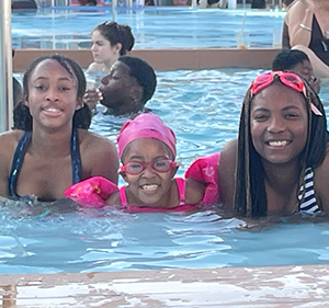 Saniya at the pool with sisters